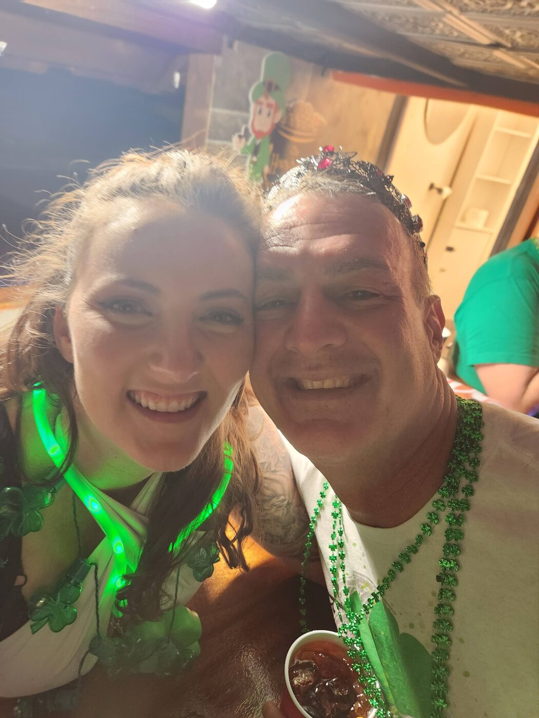 Krewe members in green beads at the party